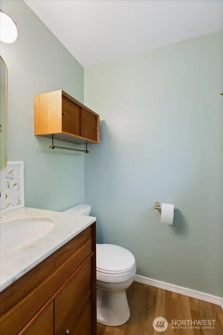 The primary bath is the perfect 3/4 bath with a towel warmer behind the door.