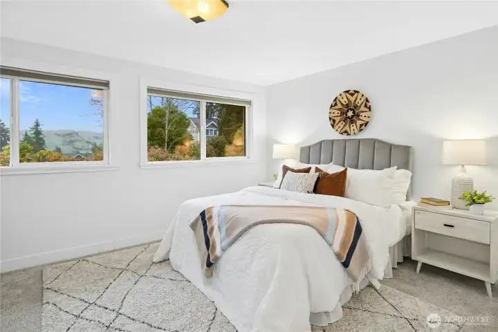 Upstairs primary bedroom is light and bright.