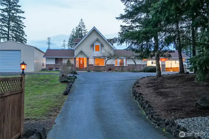 Handsome and welcoming home on a fully fenced and mostly level lot, with circular driveway, which makes it easy to pull those toys through!