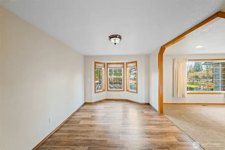 Formal dining room offers a large space to gather, easy care LVP flooring and a bay window with views toward the lake
