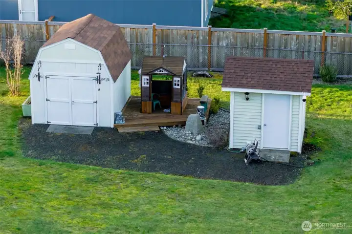 More outbuildings....you will never lack storage space. Each one is neat as a pin. Well house to right.