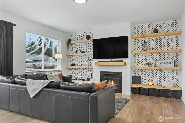 View of your family room from the kitchen. I really love the propane gas fireplace for cooler days & nights, and the included built-ins on both sides of the fireplace, stunning!