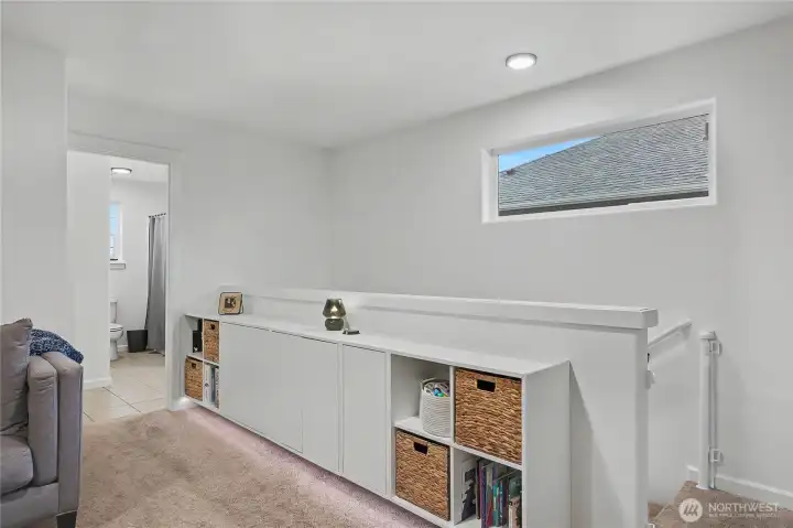 View of your upstairs landing/loft and amazing built-in storage. Kids/guest full bath to your left.