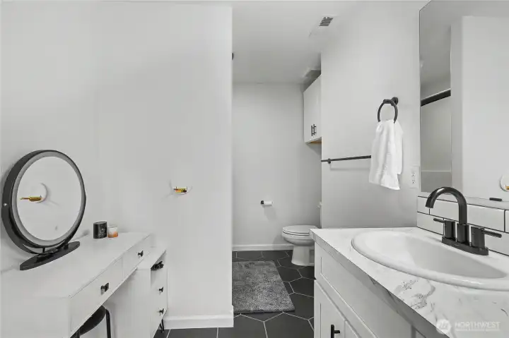 Primary ensuite full bath, love the makeup table on the left!