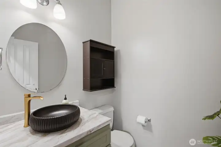 Main level half bath offering added convenience for guests and everyday use.