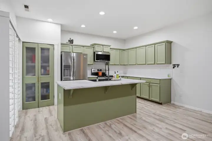 Kitchen showcasing a practical layout with abundant cabinetry and prep space.