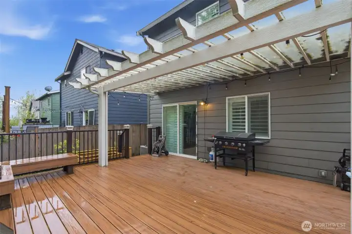 Backyard featuring a covered porch, built-in seating area, and dedicated garden space.