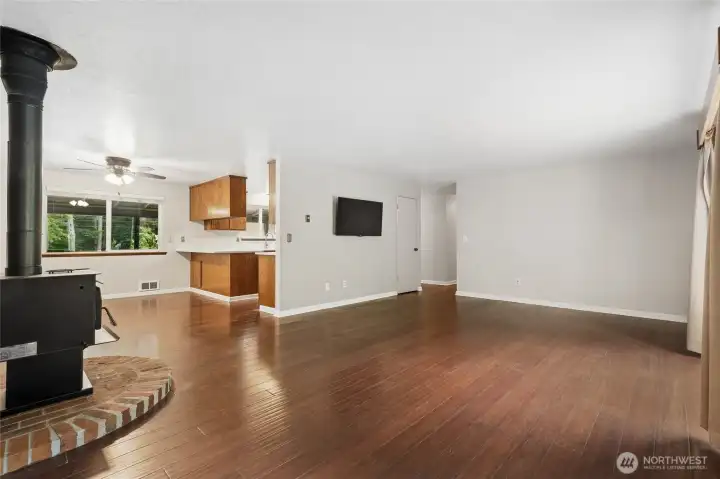 Livingroom with a wood burning fireplace and slider to the backyard.