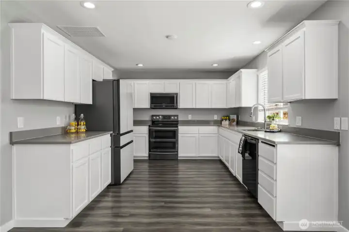 Bright kitchen with modern cabinetry, stainless steel appliances, and ample counter space