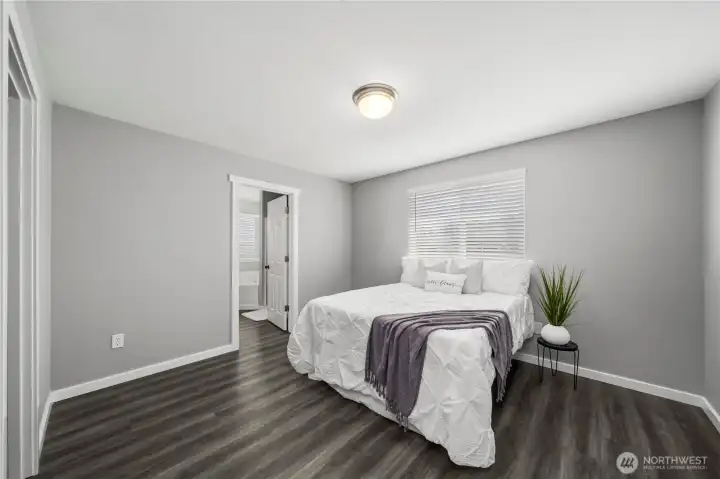 Spacious main bedroom with abundant natural light and private ensuite access