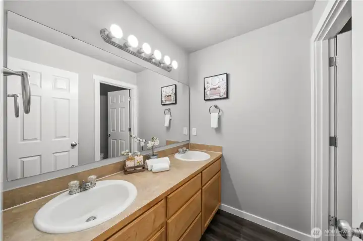 Hall bathroom with separate area for toilet and tub, offering added privacy and functionality