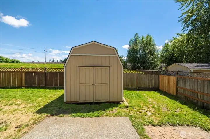 Backyard storage shed offering additional space for tools, lawn equipment, or hobbies