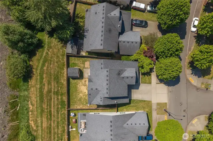 Aerial view showcasing the spacious lot, backyard, and surrounding neighborhood