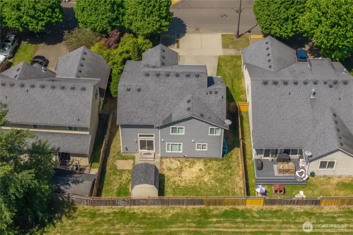 Aerial view highlighting the fully fenced backyard and neighborhood setting