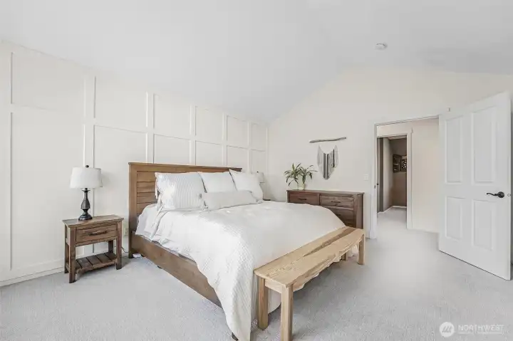 Primary bedroom with vaulted ceilings.