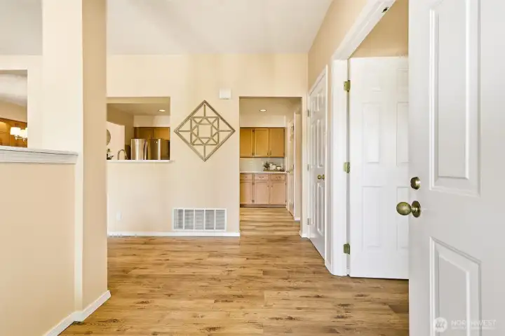 Welcoming entry with durable laminate plank flooring and open sightlines to the living areas. Welcoming entry with durable laminate plank flooring and open sightlines to the living areas.