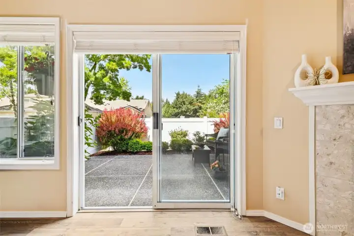 Large windows and sliding glass door bring in natural light and garden views. Large windows and sliding glass door bring in natural light and garden views.