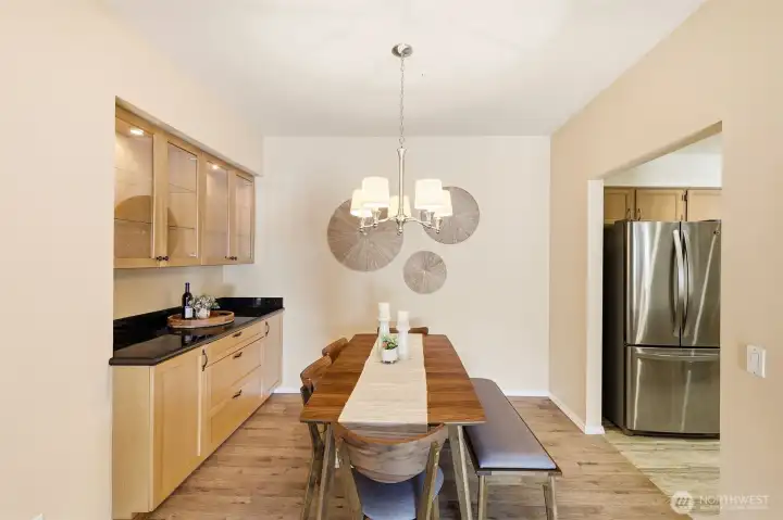 Dining room with built-in buffet, display cabinets, and ample space for gatherings. Dining room with built-in buffet, display cabinets, and ample space for gatherings.
