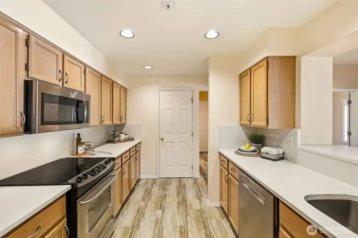 Updated kitchen featuring newer Bosch dishwasher, abundant cabinetry, and custom pull-out shelving. Updated kitchen featuring newer Bosch dishwasher, abundant cabinetry, and custom pull-out shelving.