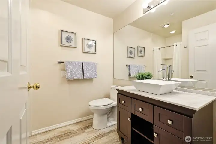 Updated guest bath featuring a vessel sink, updated vanity, modern fixtures, and step-in Jacuzzi shower. Updated guest bath featuring a vessel sink, updated vanity, modern fixtures, and step-in Jacuzzi shower.