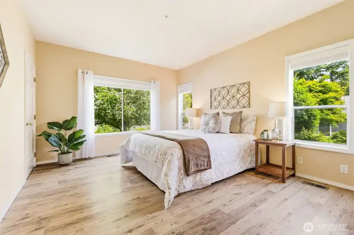 Generous primary retreat featuring large windows and ample space for additional furnishings. Generous primary retreat featuring large windows and ample space for additional furnishings.