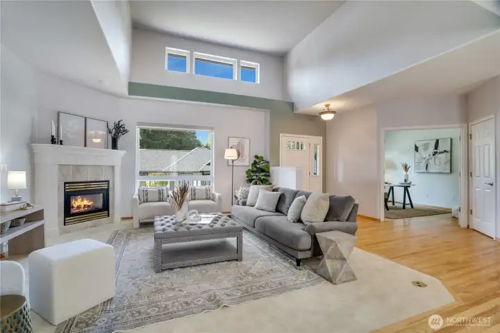Dramatic vaulted ceilings invite natural light to pour into the open great room, creating a warm and welcoming atmosphere.