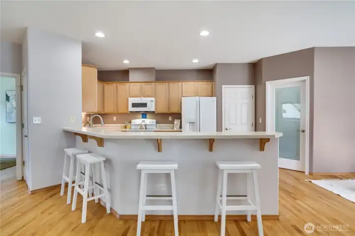 This heart of the home kitchen allows cooking and connection, with exceptional storage and an efficient layout.  Office to the left, laundry to the right.