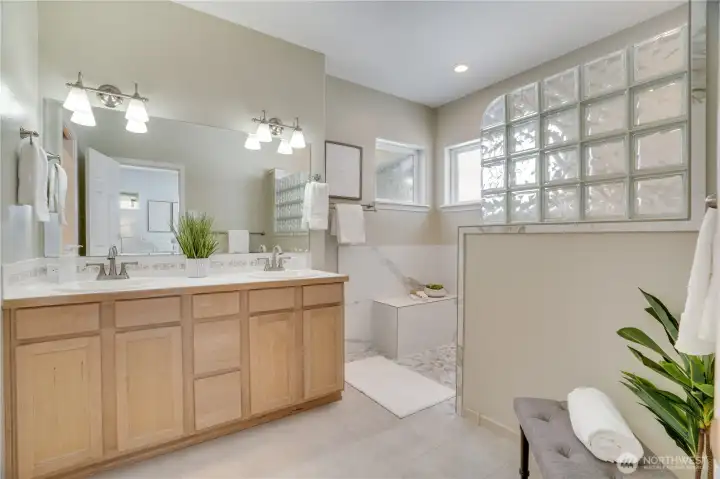 The owner thoughtfully upgraded the ensuite bath with accessibility features, including a beautiful natural stone walk-in shower.