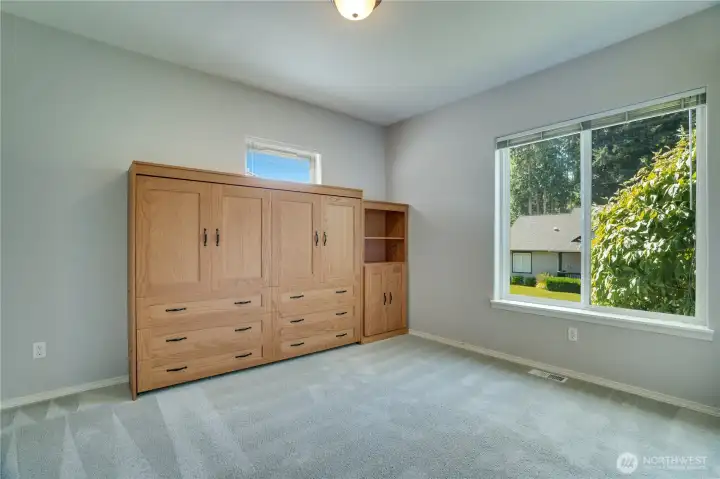 The spacious second bedroom offers incredible versatility, with a built-in library bed to transform the space from a comfortable guest room to a hobby room