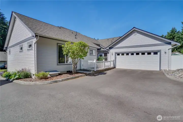 A generously sized two-car garage is thoughtfully tucked around back, keeping the home's curb appeal clean while adding everyday convenience