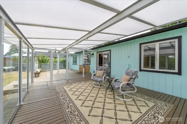 Large deck with glass awning covering.