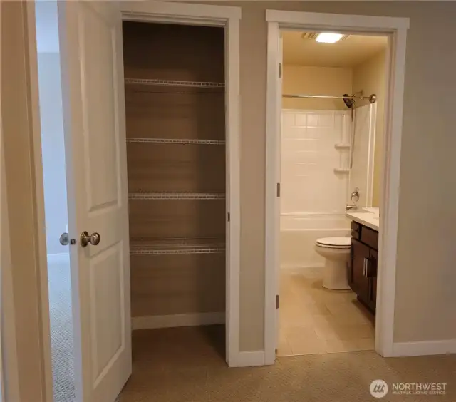 The linen closet has ample storage.