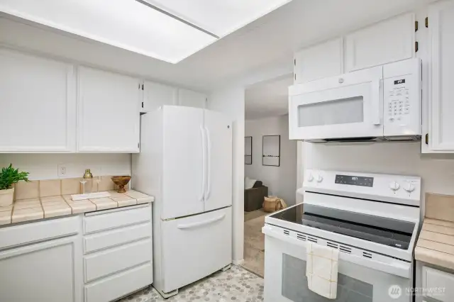 kitchen opening to casual dining area & den w/ backyard access