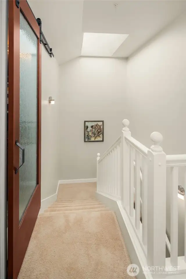Stair leading to primary suite on 2nd floor of unit