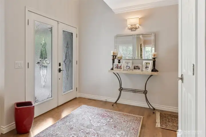 The home’s entryway welcomes you with gleaming hardwood floors that set the tone for elegance throughout.