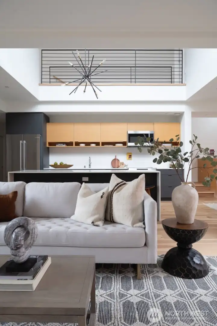 The kitchen boasts impressive double-height ceilings and features a generous island, creating a stunning focal point and providing ample space for culinary activities.