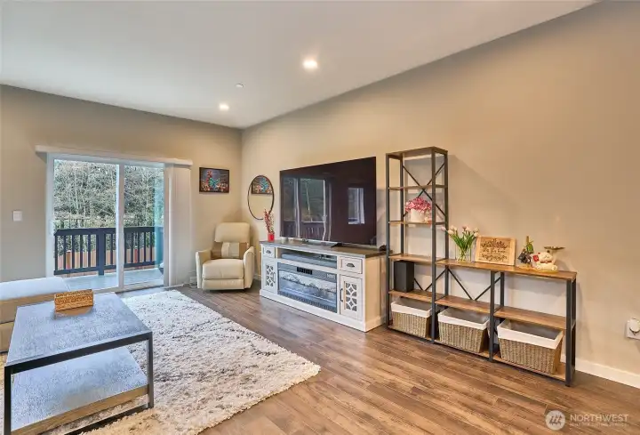 Spacious, living area, door to deck. Lots of natural light.