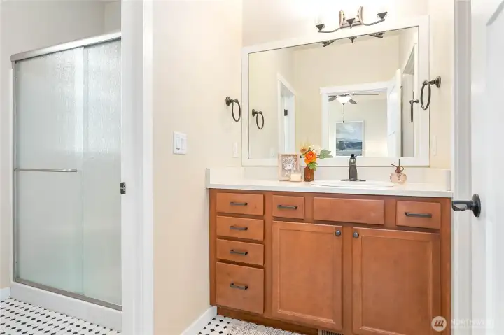 Ensuite has large walk-in shower in separate room from vanity. Pretty checkered ceramic tile flooring
