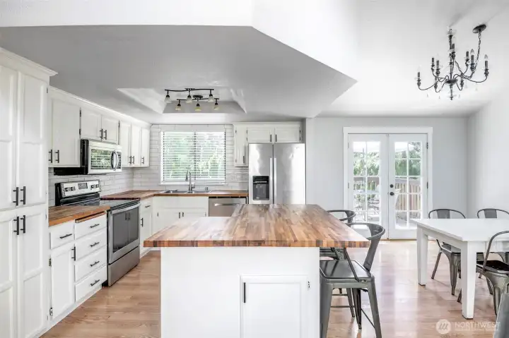 Open kitchen. All SS app.stay, butcher block countertops.
