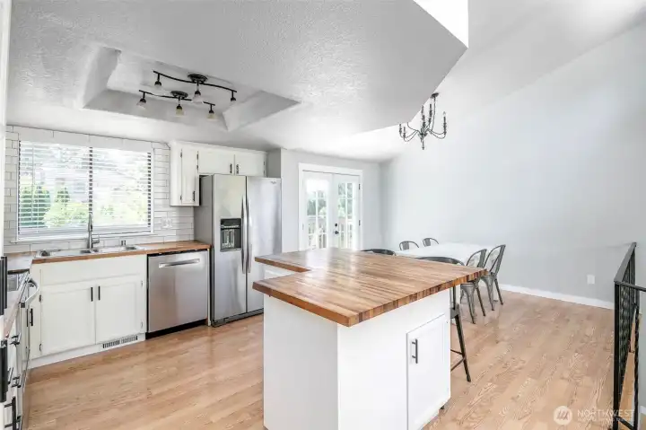 Kitchen and dining room are connected. French doors lead to ouside deck.