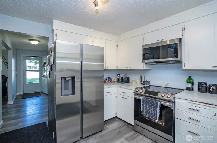 Another view of the kitchen showcasing abundant cabinet space and excellent storage throughout.