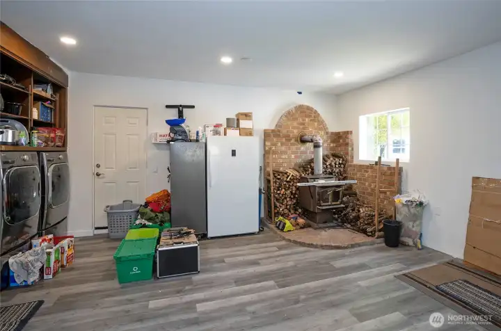 Converted garage now serves as the family room, complete with a cozy woodstove for added warmth and comfort.