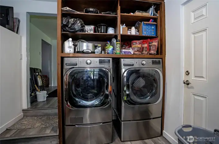Utility area in the family room featuring additional shelving for extra storage and organization.