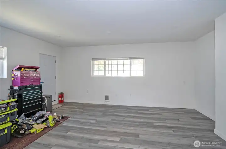 Another view of the family room with exterior access through the door, offering easy indoor-outdoor flow.