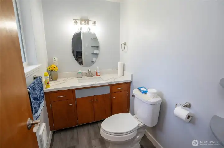 Private half bath located off the primary suite for added convenience.