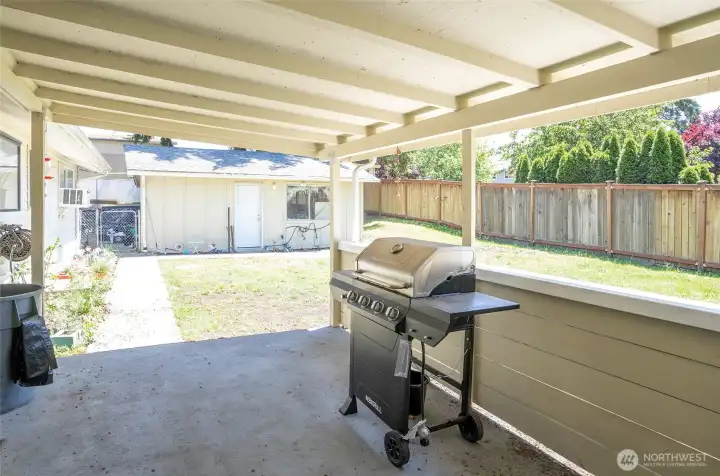 Another view of the covered back patio looking toward the detached garage.