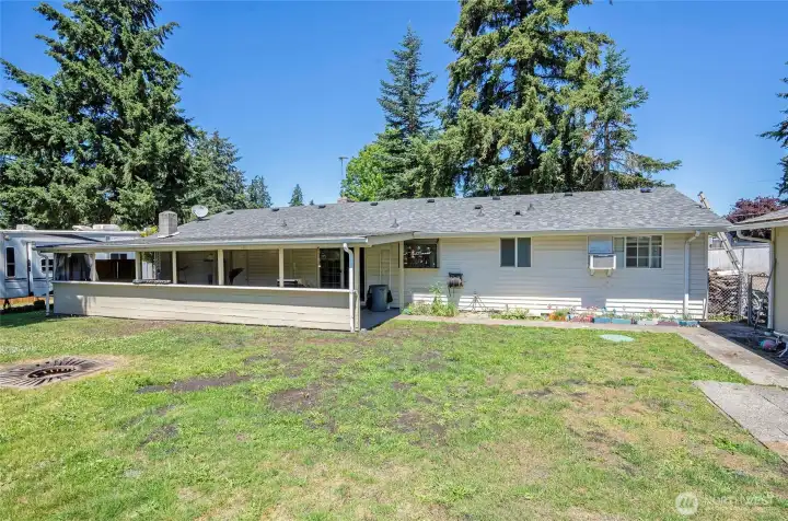 Backyard view with the detached garage situated to the right.