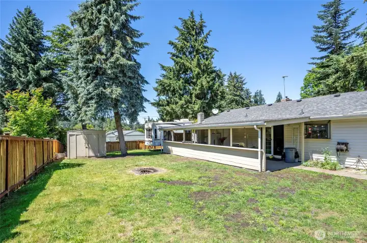 Great perspective of the backyard featuring the shed, which houses a 10K generator and a Generac sub panel.