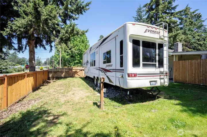 Side yard featuring RV parking with a power hookup for added convenience.