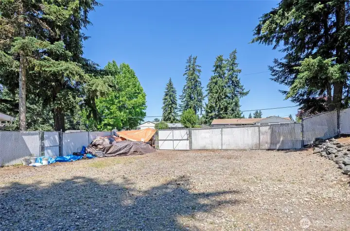 View from the detached garage looking toward the street, with the property fully fenced for privacy and security.